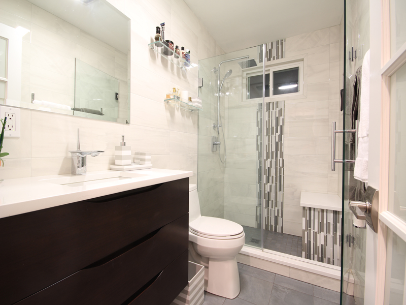A larger shower with a seat can enhance the bathroom space.
