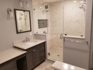 View of attractive bathroom with large walk-in shower, cabinet, and sink