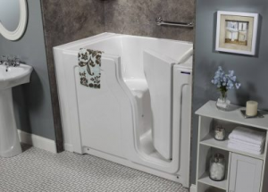 attractive walk-in tub next to small bathroom cabinet and sink